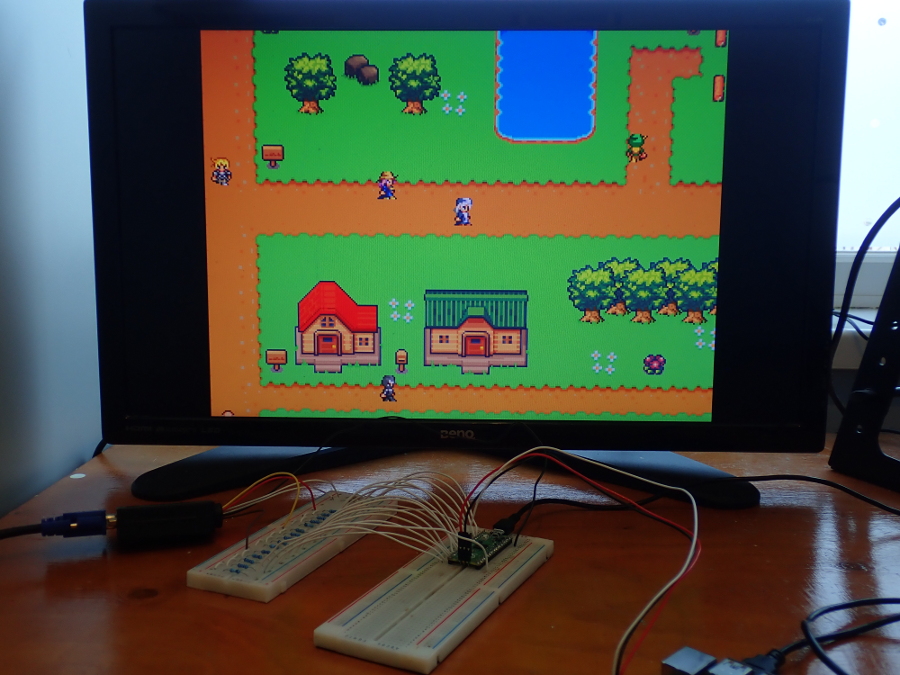 A monitor attached to a pico displaying some character sprites over a tile map